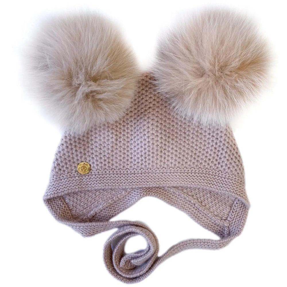 Petite Maison Kids Honeycomb Dusty Pink Cashmere Bonnet with two fluffy cream pom poms perched on top.