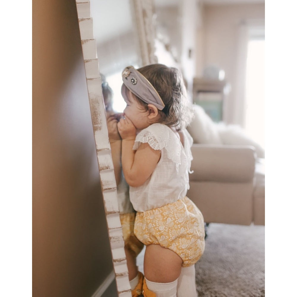 Petite Maison Kids Kylie headband worn by toddler; gray fabric with decorative accents.