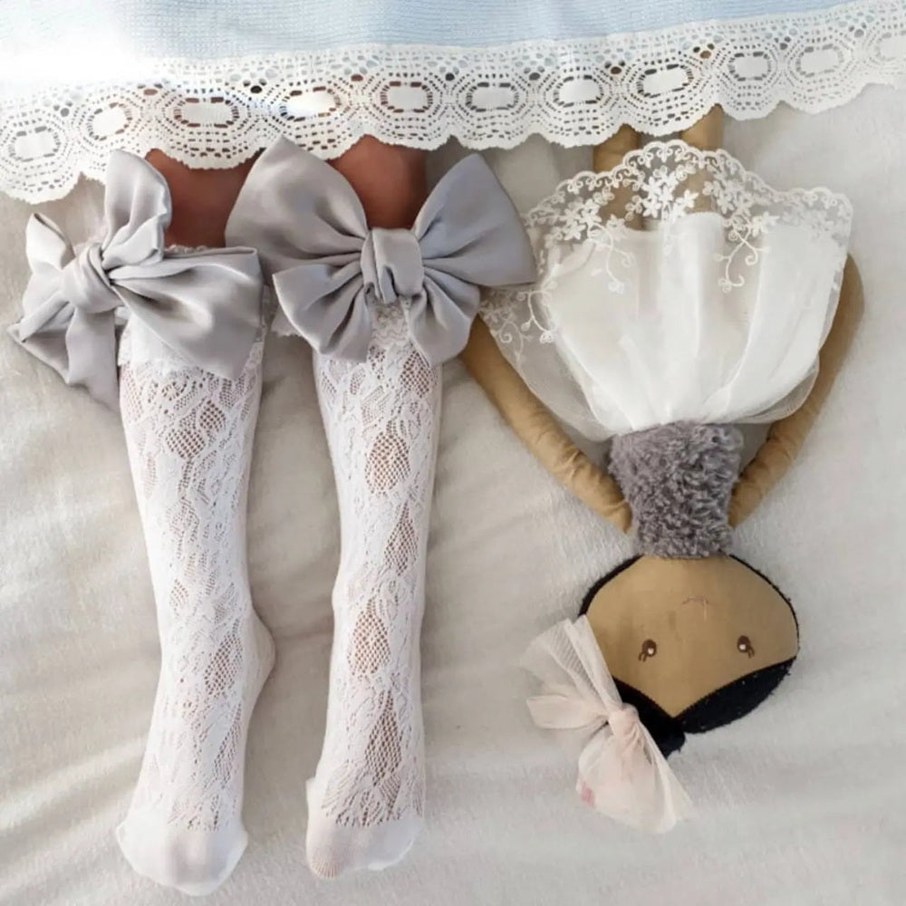 Petite Maison Kids Lola Lace Socks With Satin Bows; white lace knee-highs tied with big gray satin bows.