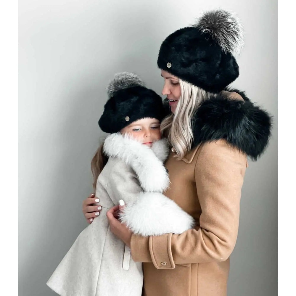 Petite Maison Kids Milana Noir Beret worn by mother and child, black fur-pom hats with silver badge.