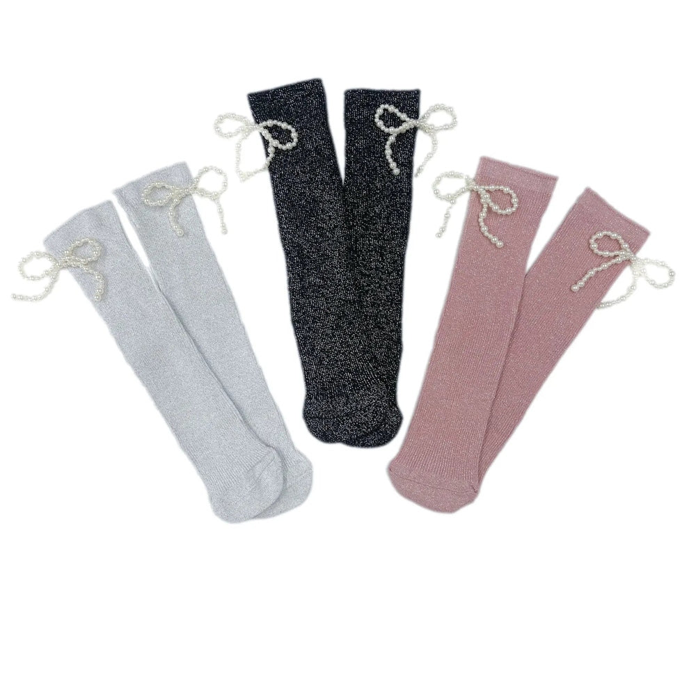Petite Maison Kids Perla Shimmer Socks: five glittery knee-highs fanned out in gray, light gray, black, and pink with pearl bow ties.