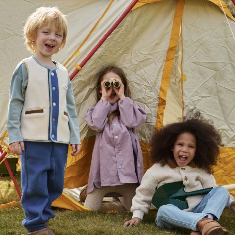 Petite Revery corduroy dress Lilac Blush for toddlers; lavender dress worn by a child outdoors near a tent