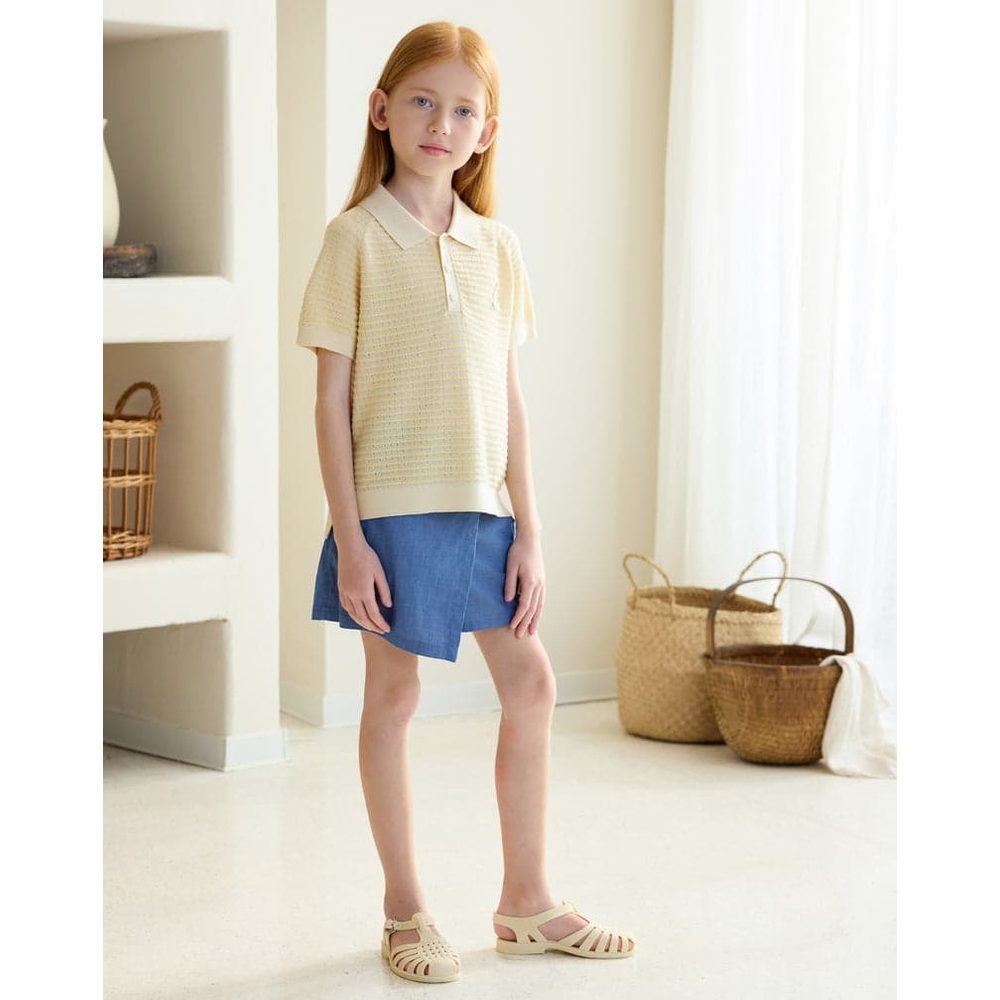Petite Revery Cotton Knit Short Sleeve Top Mellow Yellow worn by a girl, showcasing soft knit texture and polo collar.