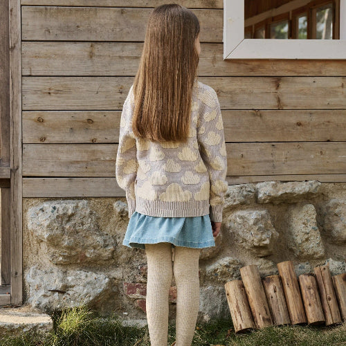 Petite Revery cotton knit sweater in lilac blush, toddler girl back view with beige tights.