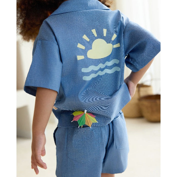 Petite Revery blue denim shorts for babies with back pocket and a colorful umbrella clip.