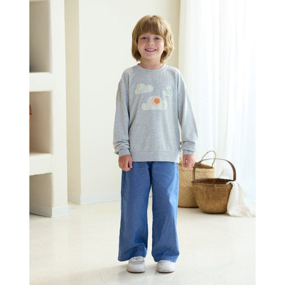 Petite Revery French Terry Drop Shoulder Long Sleeve Sweatshirt Fog Grey, a smiling toddler wearing a cloud-graphic top
