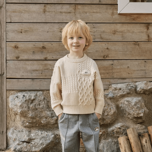 Petite Revery slate gray wide-leg baby/toddler pants worn by a smiling toddler boy