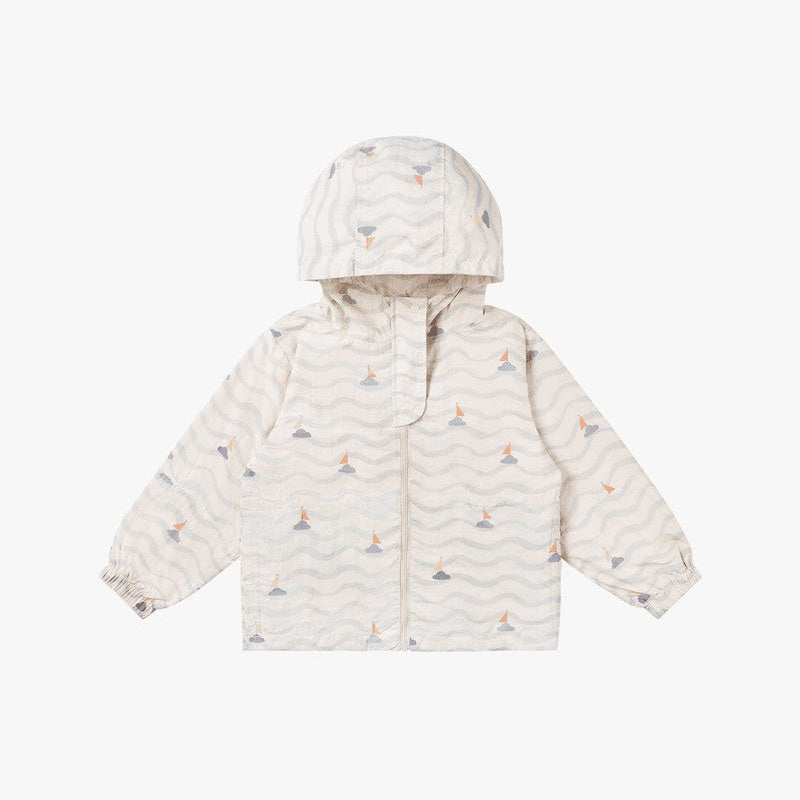 Petite Revery Hooded Windbreaker Sea La Vie jacket, cream with blue waves and orange sailboats, hooded, laid flat.