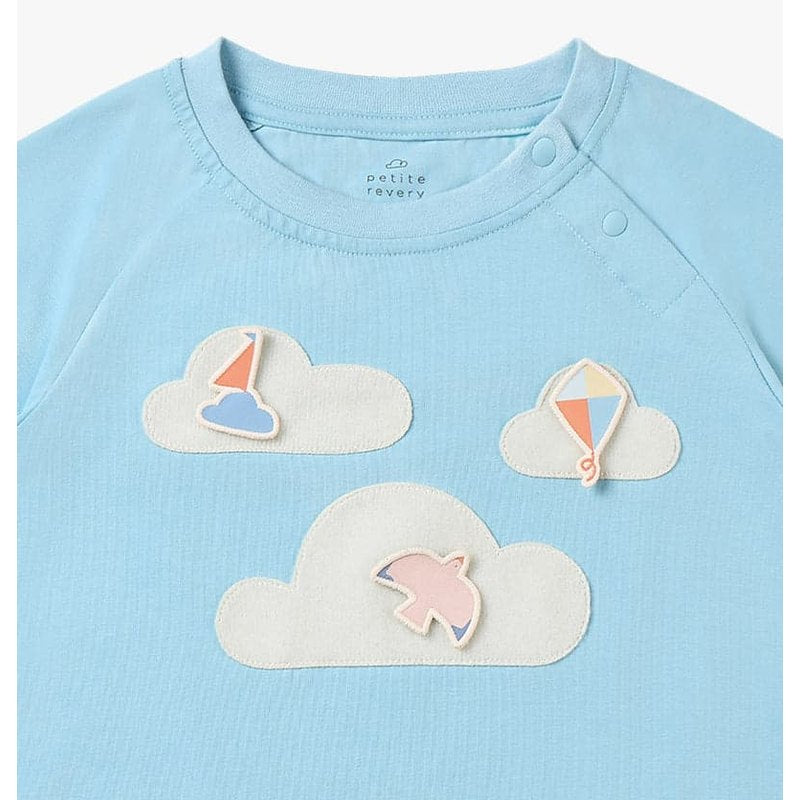 Petite Revery Forget-Me-Not Quick Dry raglan tee in light blue with cloud patches and sailboat appliqués.
