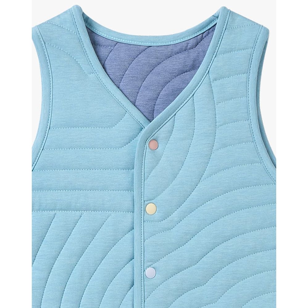 Petite Revery Quilted Cloud Vest Forget-Me-Not, light blue quilted baby vest with pastel snap buttons fastening front.