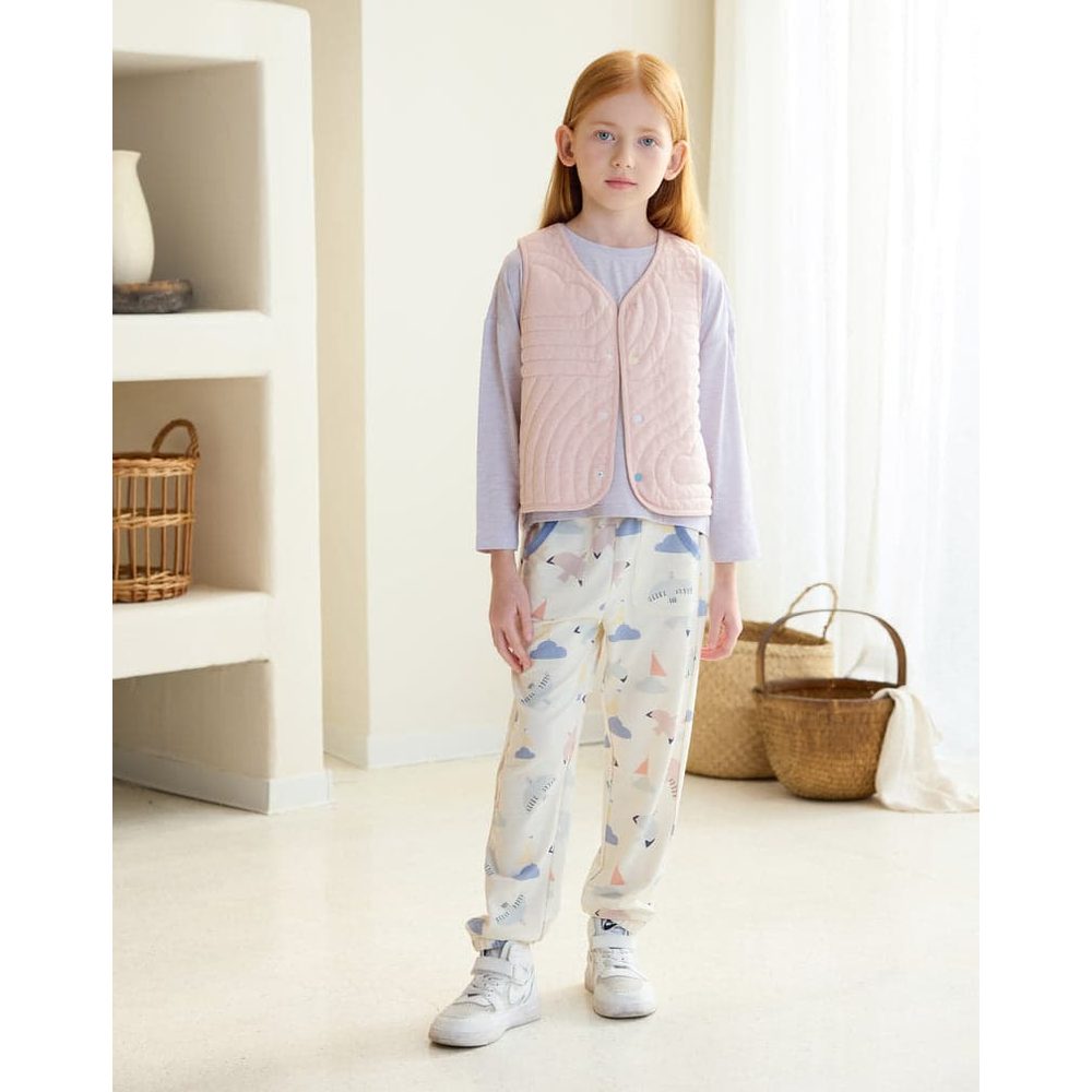 Petite Revery Quilted Cloud Vest Rose Smoke worn by a girl in pastel loungewear, pink quilted vest with front snaps fastened.