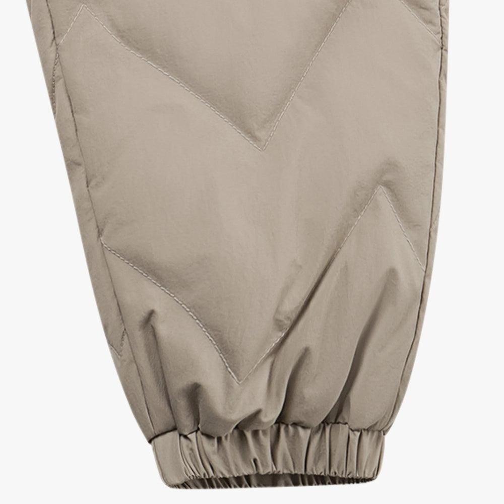 Petite Revery recycled nylon Taslon pants in pine wood beige with quilted diamond panels and elastic cuffs