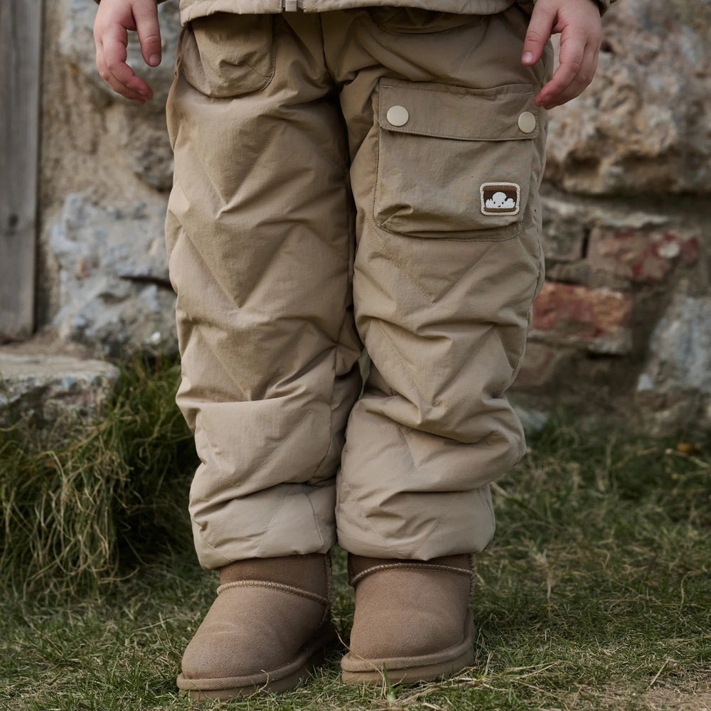 Petite Revery pants in pine wood beige, recycled nylon Taslon fabric with cargo pocket and logo badge