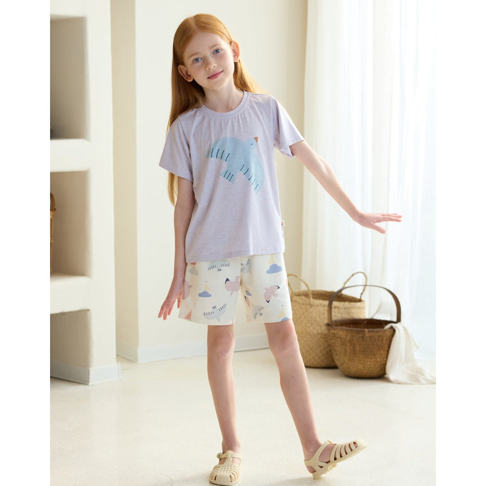 Petite Revery Short Sleeve Tee Lavender Blue on a girl, relaxed-fit top with pastel animal graphic, paired with matching shorts.