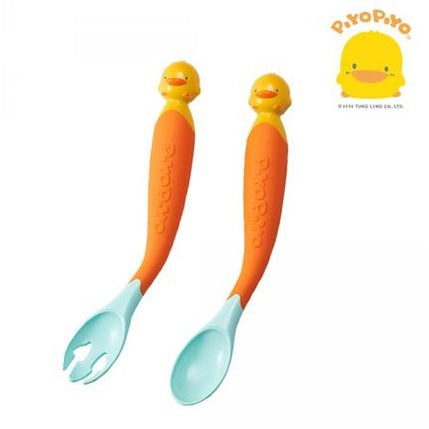 PIYO PIYO Magic Bendies Spoon & Fork Set with orange handles, yellow duck heads, turquoise tips, laid side by side for mealtime.