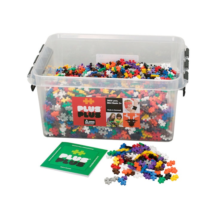 Plus-Plus Mini 3600 Educational building toy set in a clear storage tub with colorful interlocking bricks spilled nearby.