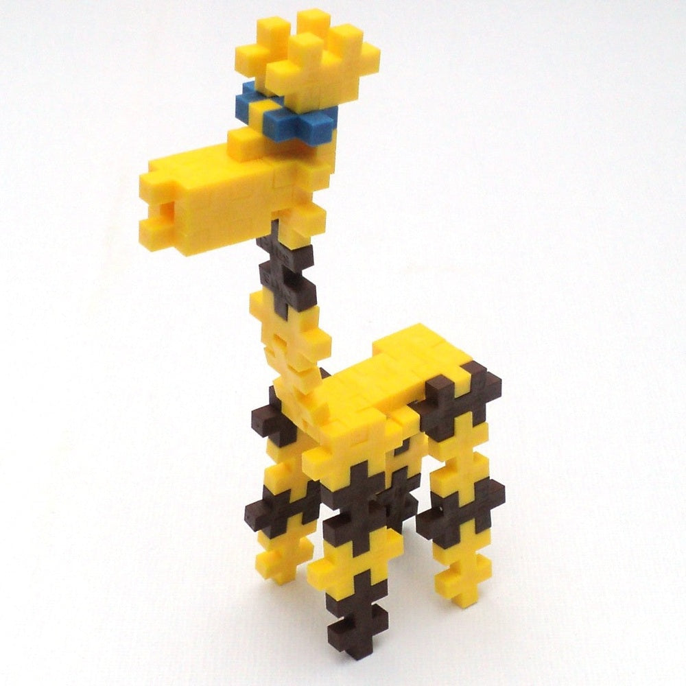 Plus-Plus Mini 3600 Educational giraffe figure, yellow/brown blocks with blue glasses, stands upright.