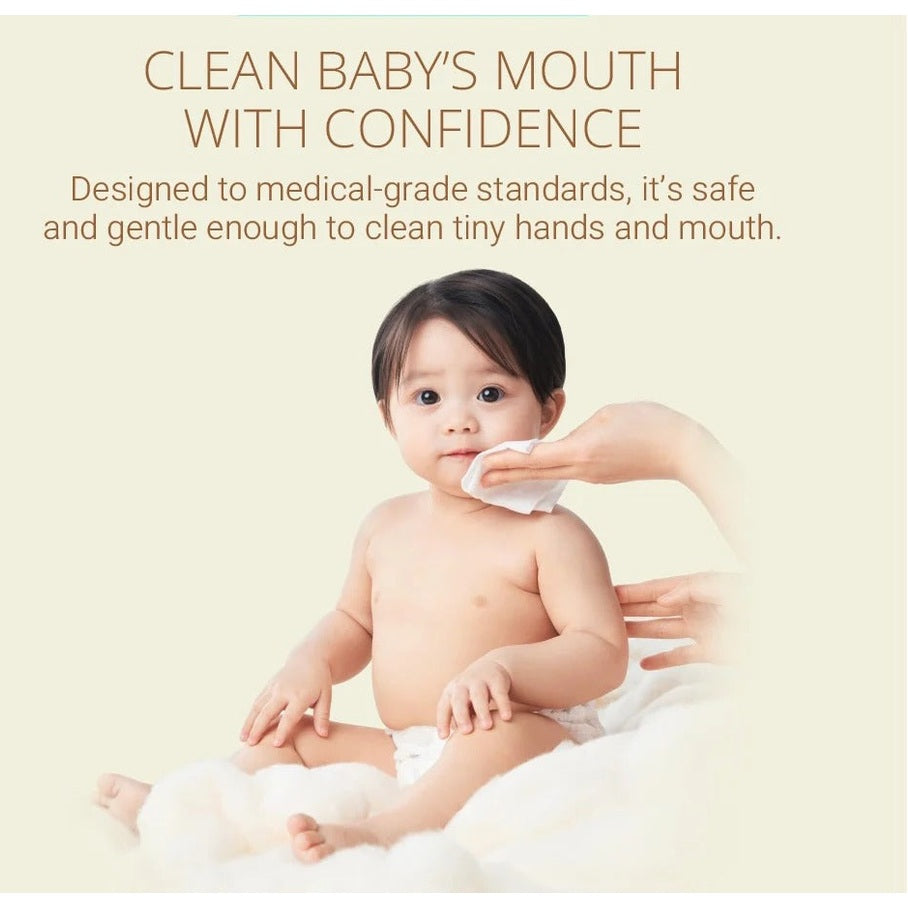 Purcotton Cotton Baby Wet Wipes 20 Sheets; a caregiver gently wipes the baby's mouth with a wipe.