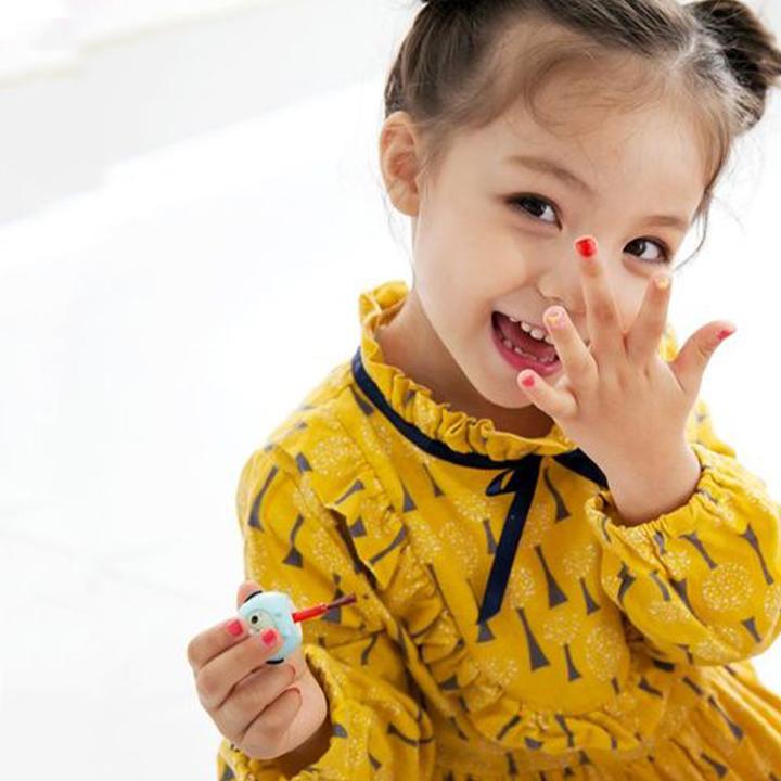 Puttisu Pangpang Nail Polish Color C12 Lovely Moment; child with colorful nails wearing a yellow patterned dress.