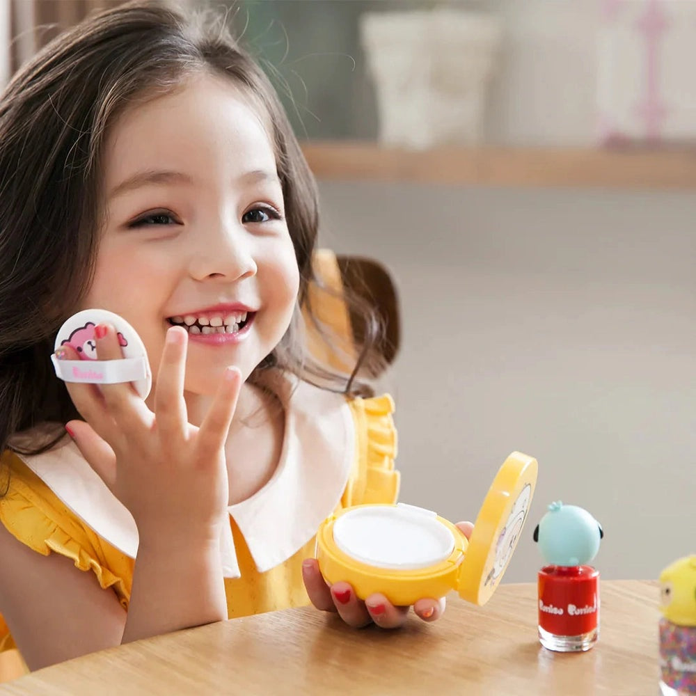 PUTTISU Safe Baby Mild Sun Cushion SPF50+ Pa++++ compact held by a smiling girl outdoors, showing sun protection.