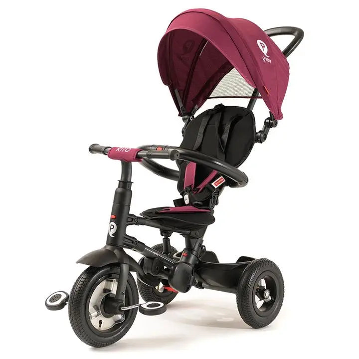Qplay Rito Plus Ultimate Folding Trike with pink canopy; adult grips curved handlebar guiding the three-wheeled ride.