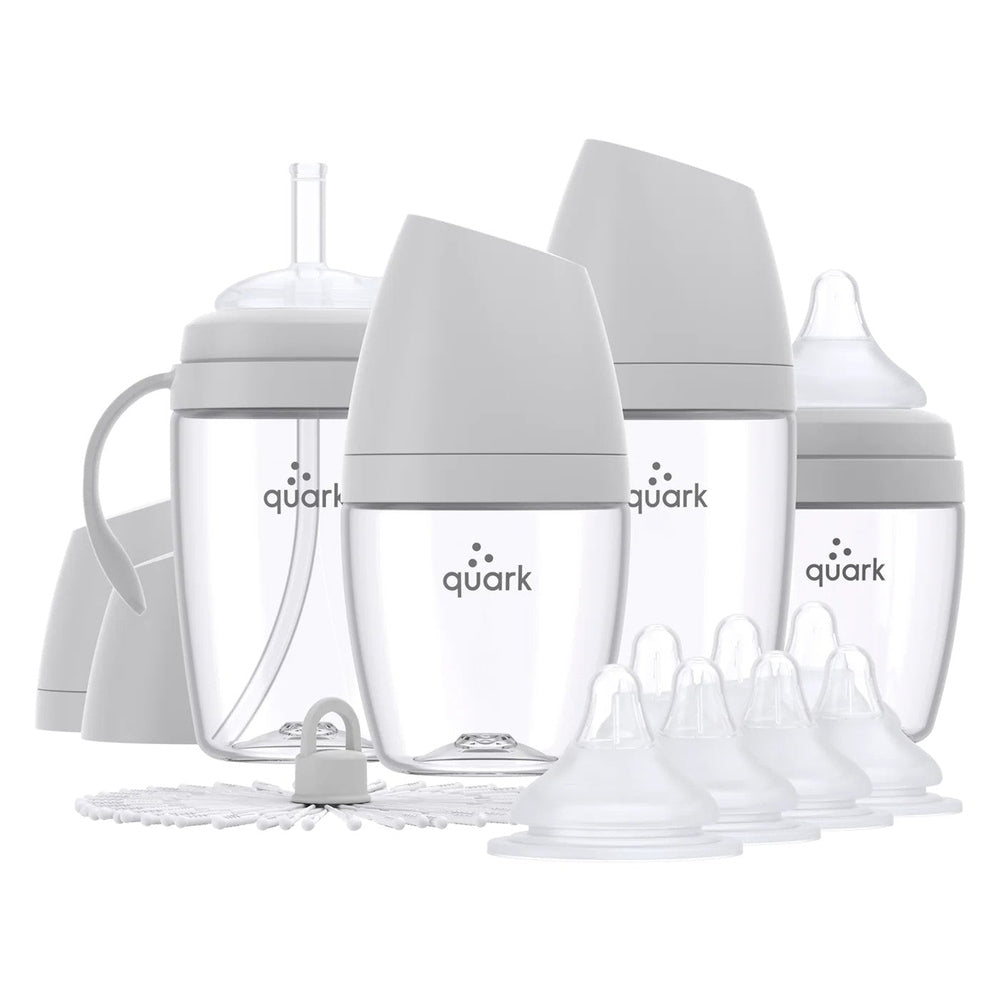 Quark Buubibottle Hybrid Feeding Bundle: four clear bottles with white lids displayed for feeding with assorted nipples and caps