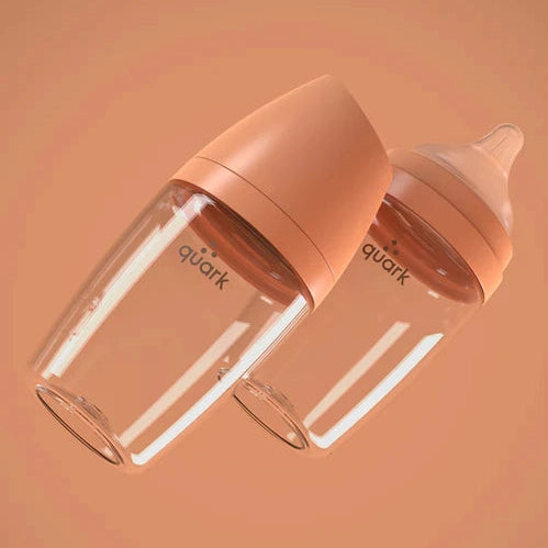 Quark Buubibottle Max Hybrid feeding bottles, peach caps, clear glass; two bottles shown