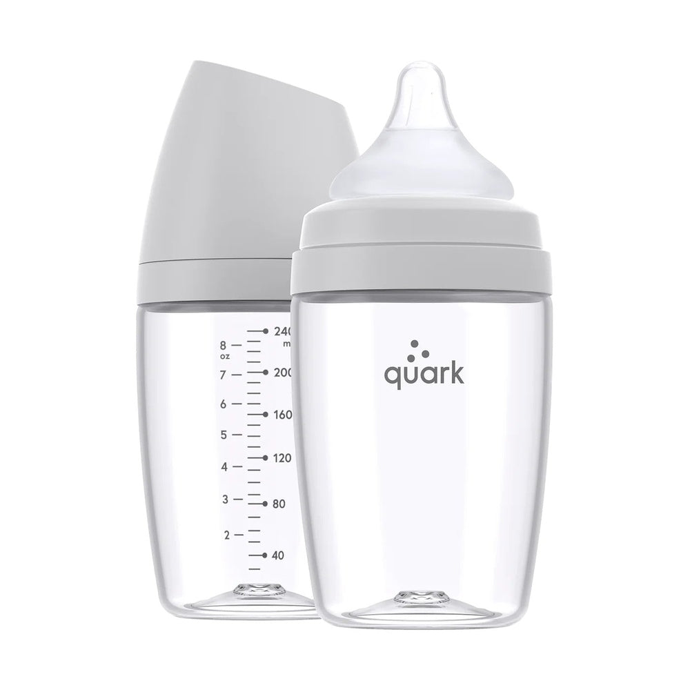 Quark Buubibottle Max Hybrid Feeding Bottle 2 Pack; clear bottles with gray caps, one shows measurement scale and silicone nipple.