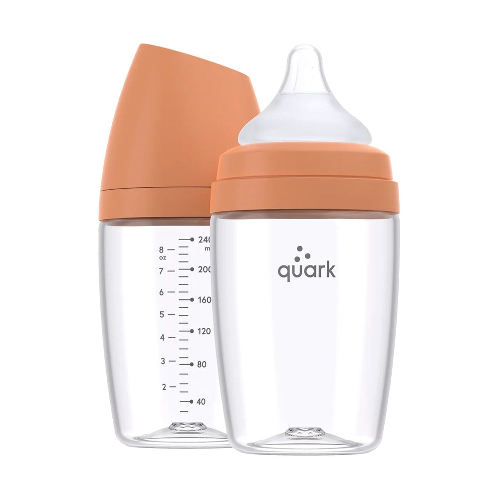 Quark Buubibottle Max Hybrid Feeding Bottle 2 Pack, clear bottles with orange caps; one shows measurement scale and nipple.