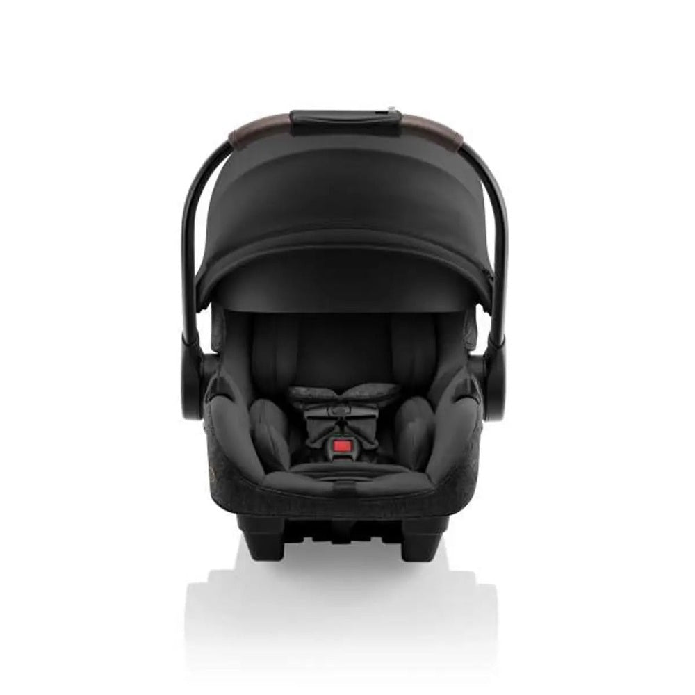 ROMER Romer Juni Infant Car Seat with Versa Base in black, baby secured in harness on the base.