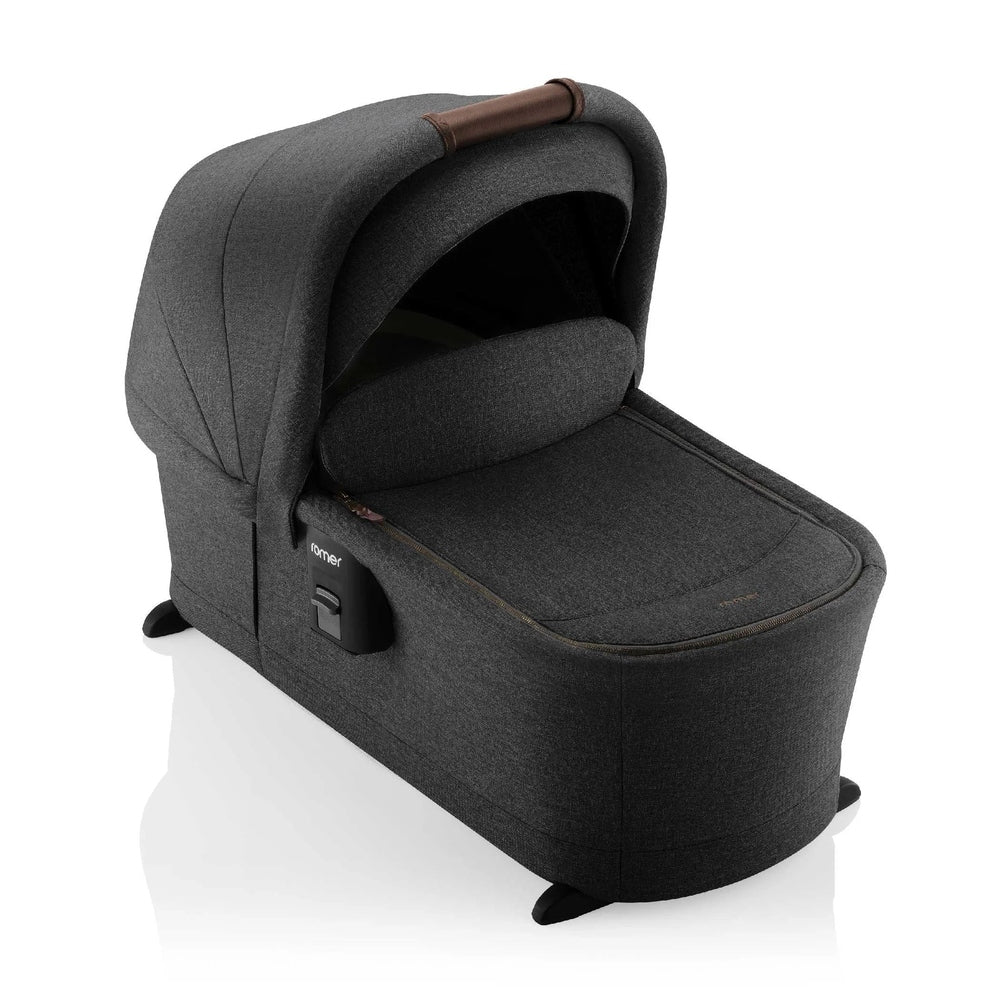ROMER Sera Bassinet for Tura Stroller in dark gray fabric with padded hood, attached to stroller base.