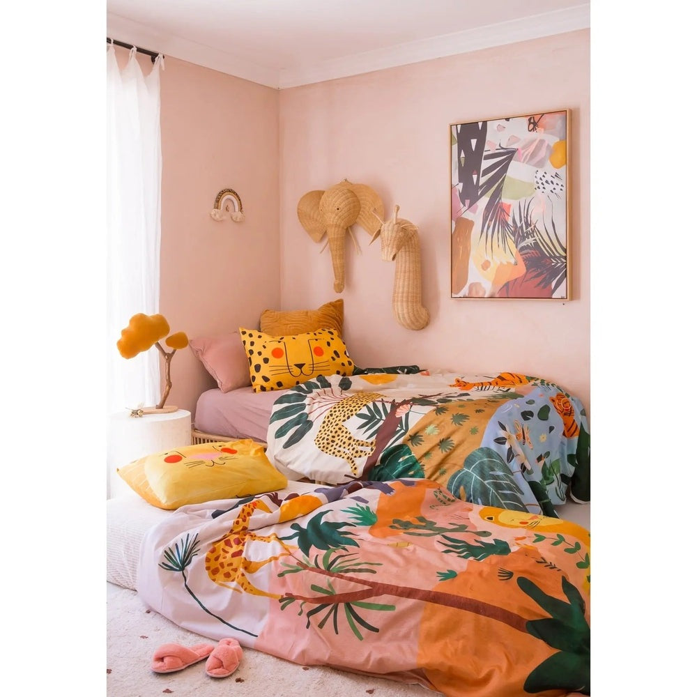 Rookie Humans Kids Bedding Set In The Jungle on a bed with tropical prints and pink, orange, yellow tones.