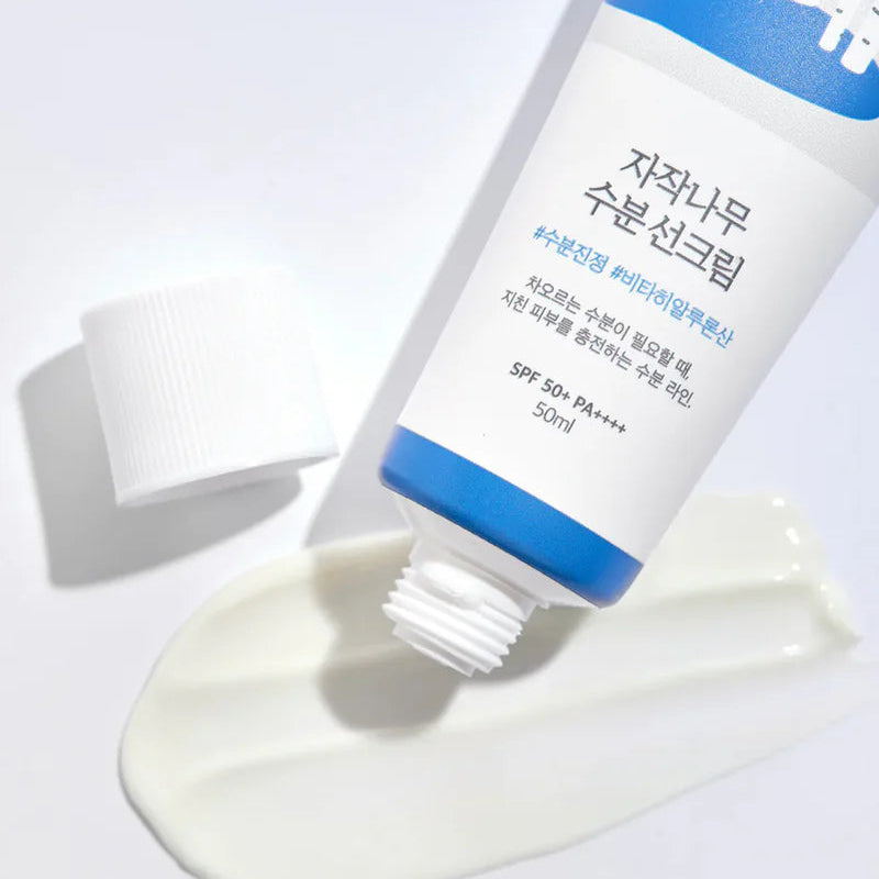 Round Lab Birch Moisturizing Sunscreen SPF50, 50 ml tube with blue cap and spilled cream