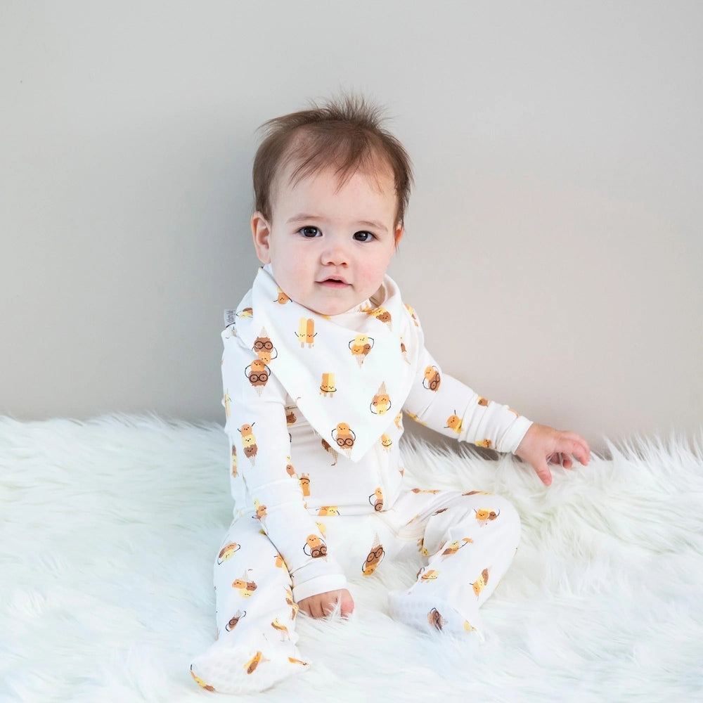 Silkberry Baby organic cotton zip-up footies in Icy Pals print; white baby onesie with orange ice cream cones.