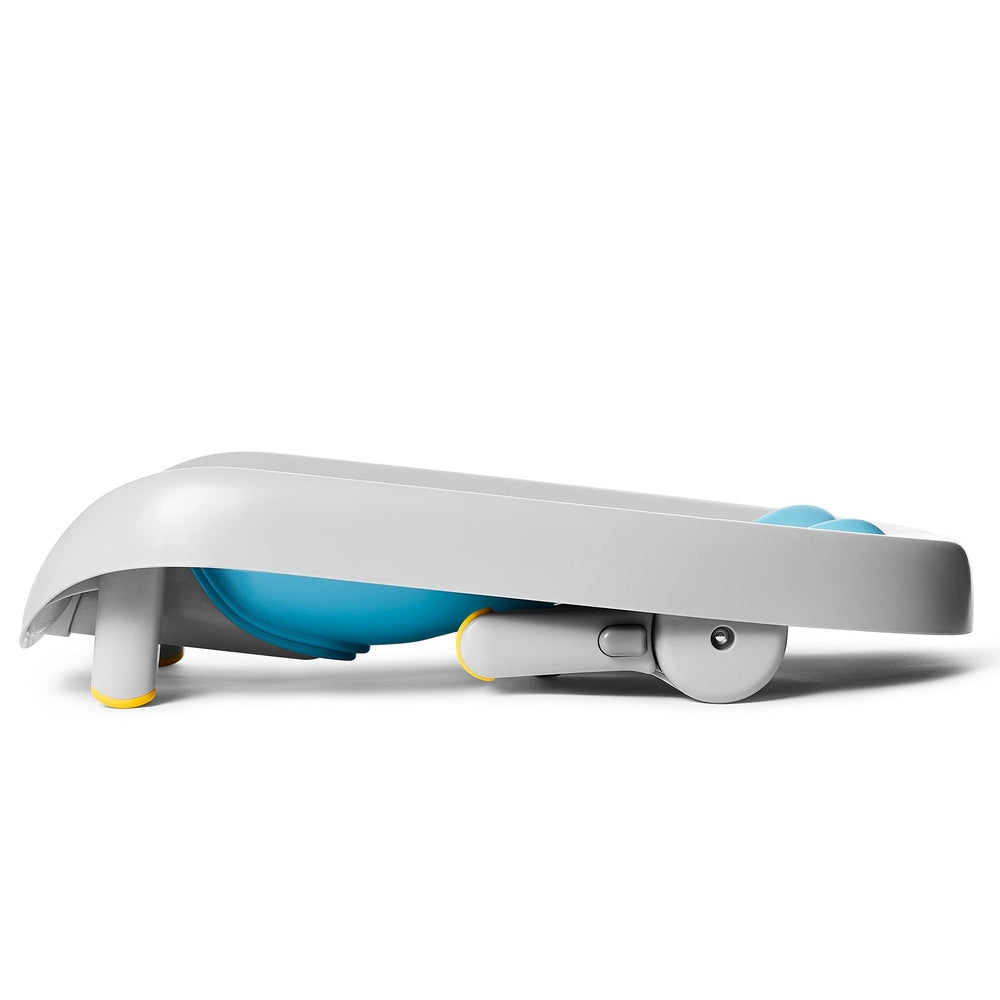 Skip Hop Moby Recline and Rinse Bather for babies; gray shell, blue interior, yellow accents.