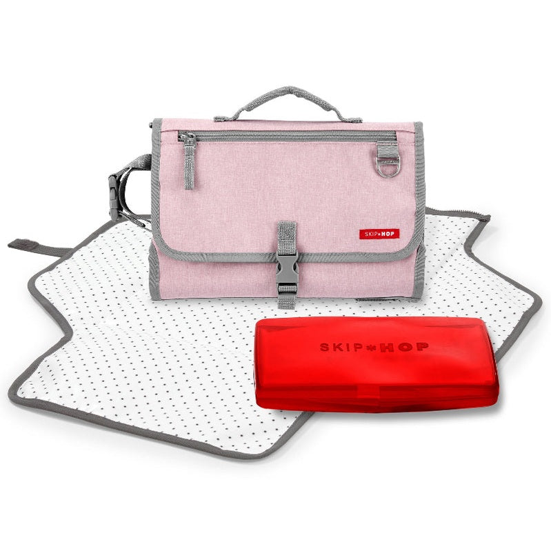 Skip Hop Pronto Signature Changing Station Pink Heather with gray trim, shown with dotted mat and red wipe case