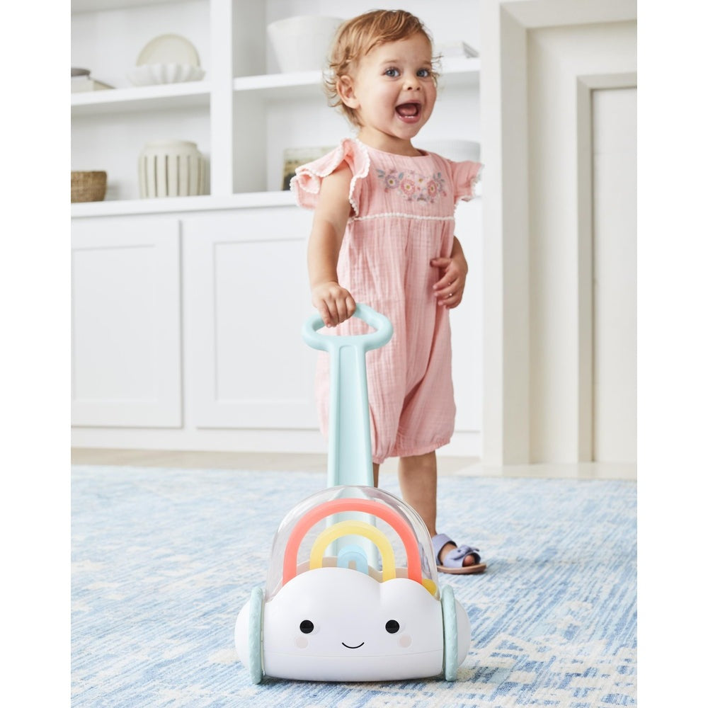 Skip Hop Silver Lining Cloud Rainbow push toy with pastel arches and smiling cloud, pushed by toddler.