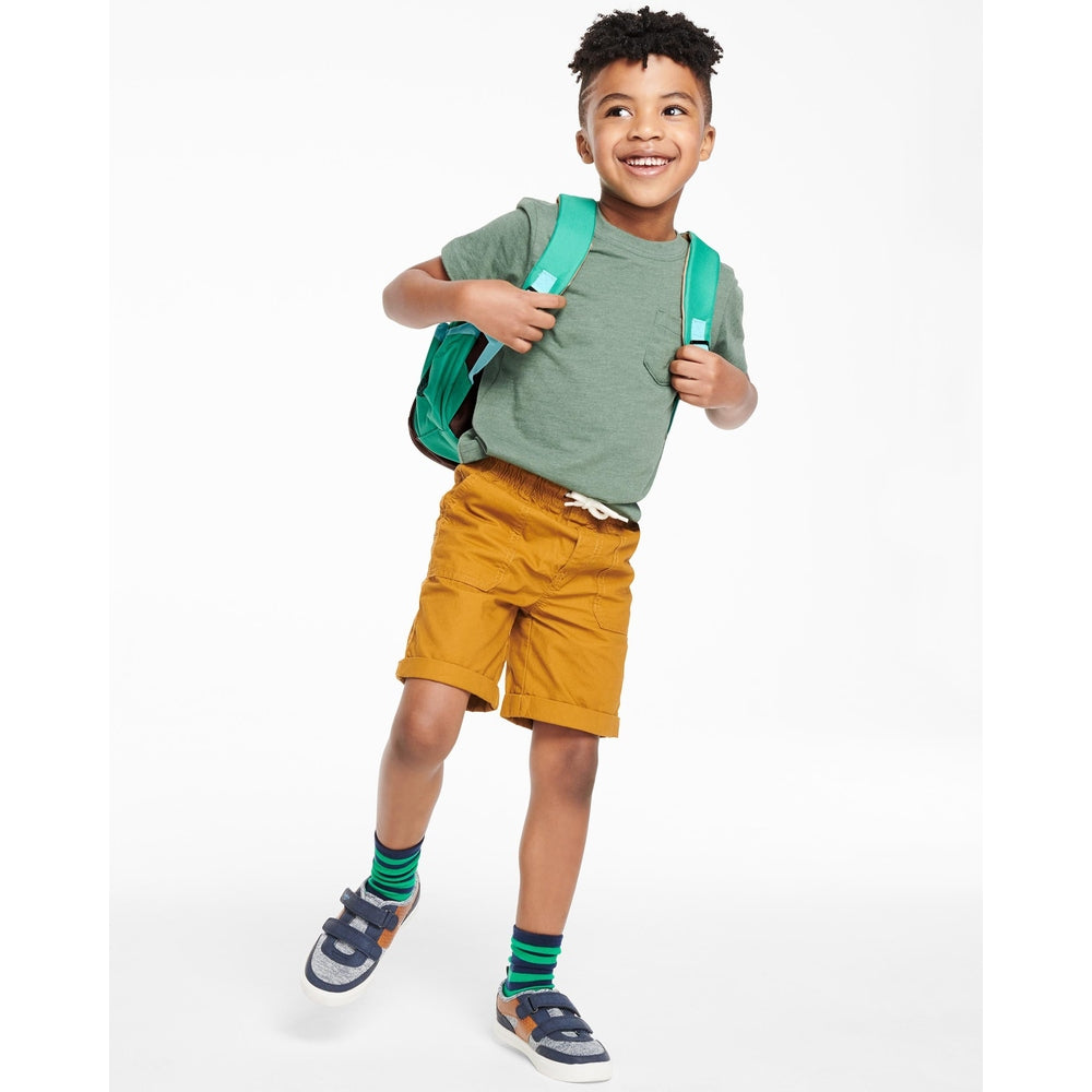 Skip Hop Zoo Little Kid Backpack Pug in green with teal straps on a smiling boy