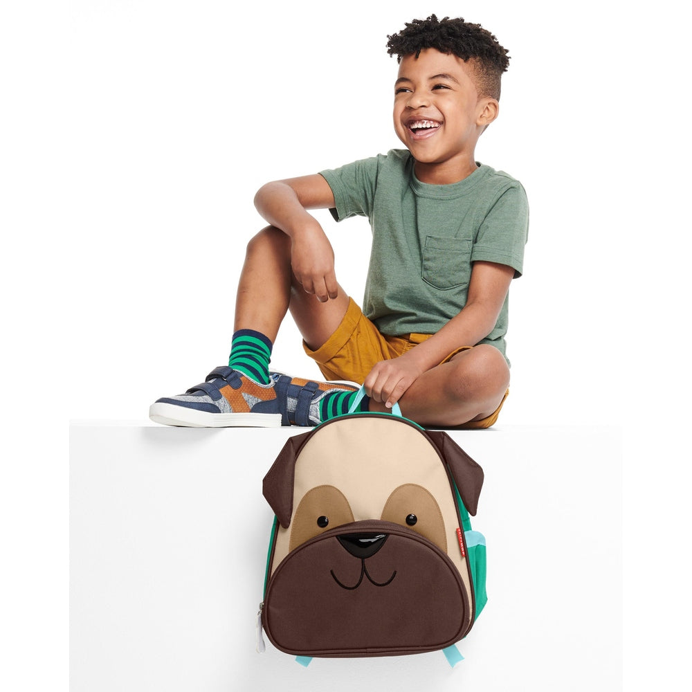Skip Hop Zoo Pug backpack for kids with beige/brown dog face and teal side pockets