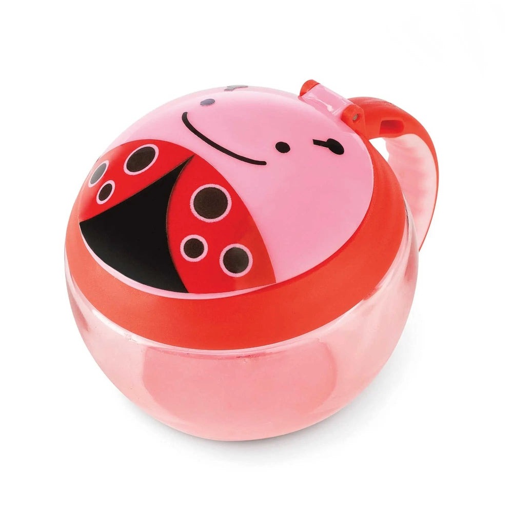 Skip Hop Zoo Snack Cup pink ladybug design with lid on and red handle for easy toddler snacking.