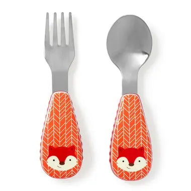 Skip Hop Zoo Utensil Set featuring orange fox-pattern handles on a fork and spoon laid side by side.