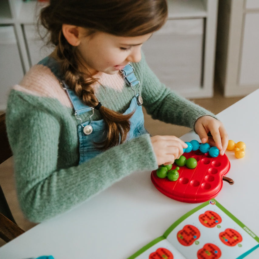 Smart Games Apple Twist toy; red apple-shaped base with colorful bead pegs for kids