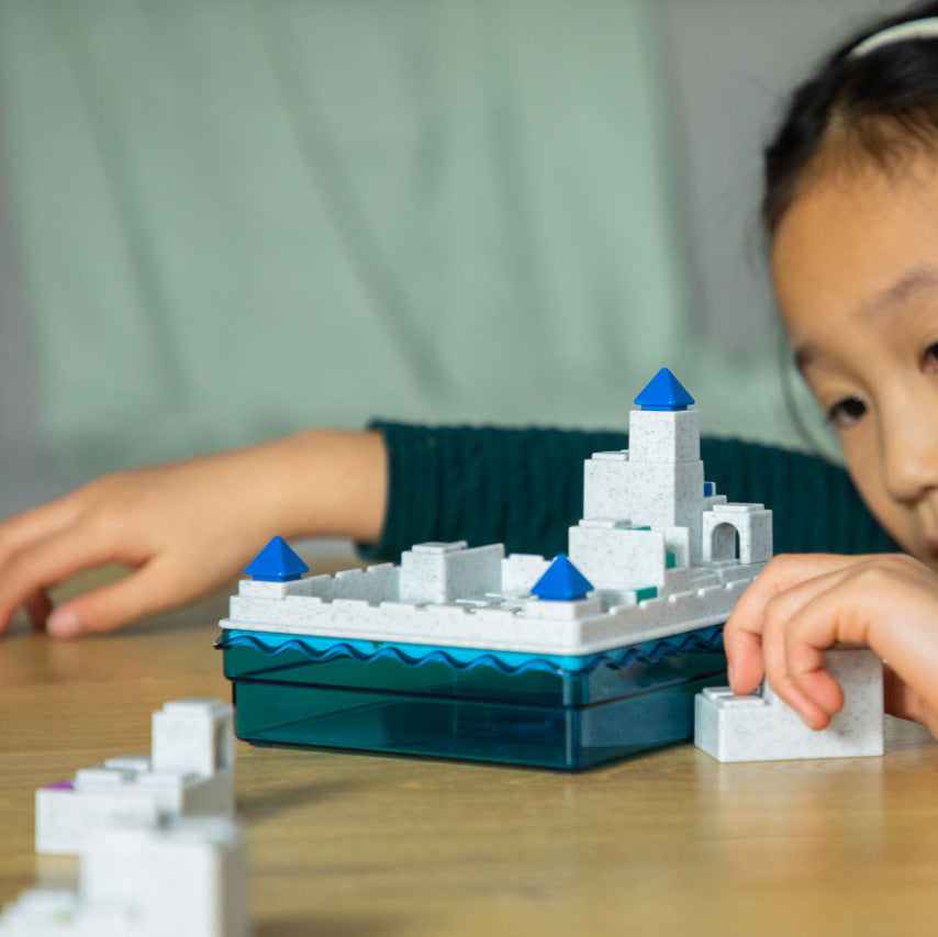 Smart Games Atlantis Escape puzzle on a blue water base with white stone blocks and blue pyramids