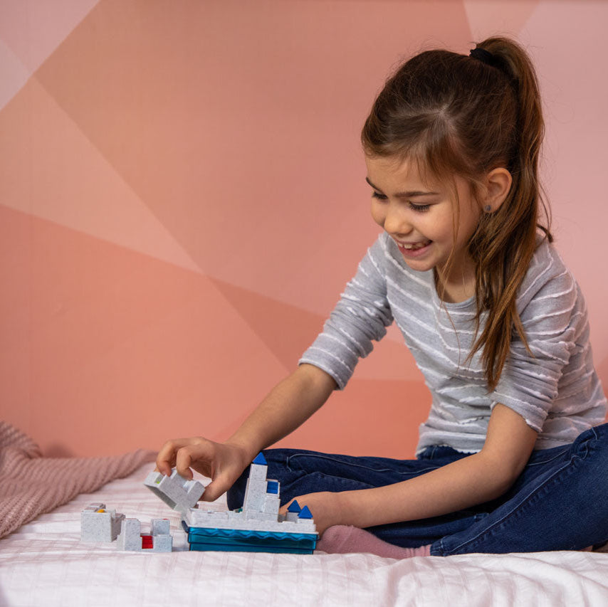 Smart Games Atlantis Escape puzzle game; gray blocks on blue base with a girl playing