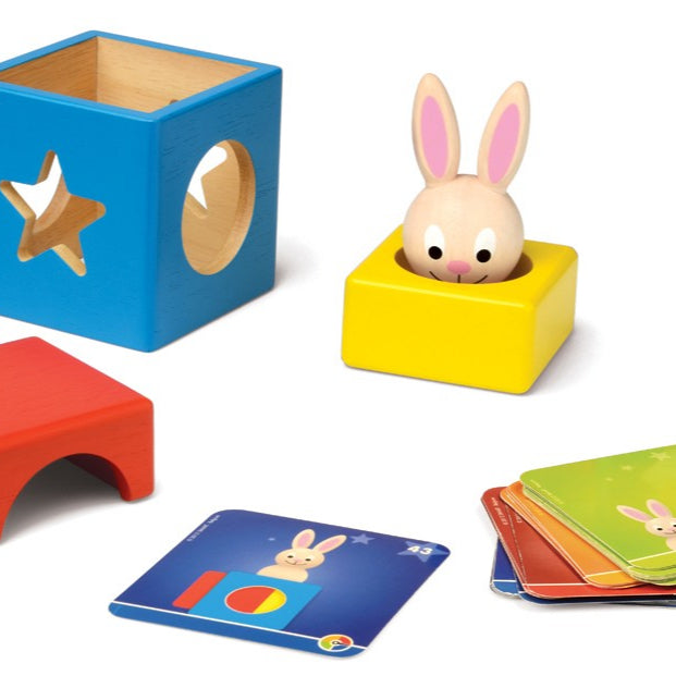 Smart Games Bunny Boo wooden educational toy set with blue star-block, yellow bunny-in-hole block, red arch, and colorful cards