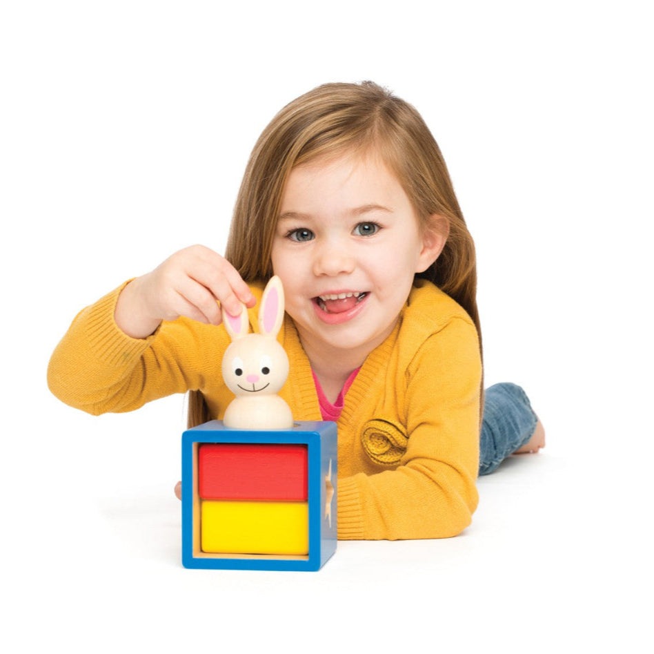 Smart Games Bunny Boo educational toy with a blue block cube and wooden bunny; child playing.