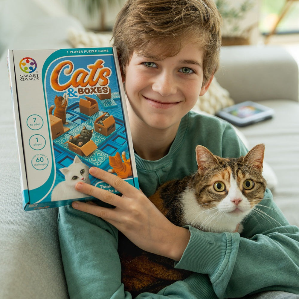 Cats & Boxes puzzle game by Smart Games; blue box with cat illustrations held by a smiling boy and cat