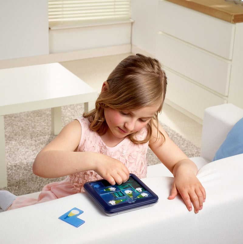 Smart Games Ghost Hunters handheld tablet game; girl in pink dress plays on blue case.