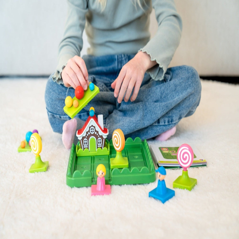 Child playing with a colorful toy set on a light-colored floor.