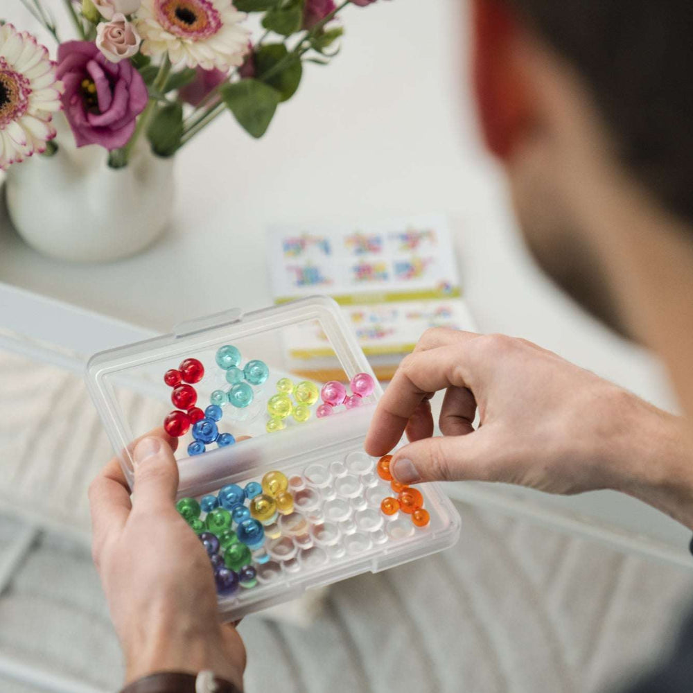 Smart Games IQ Bubbles educational toy in a clear case with multicolored translucent beads from SMART GAMES